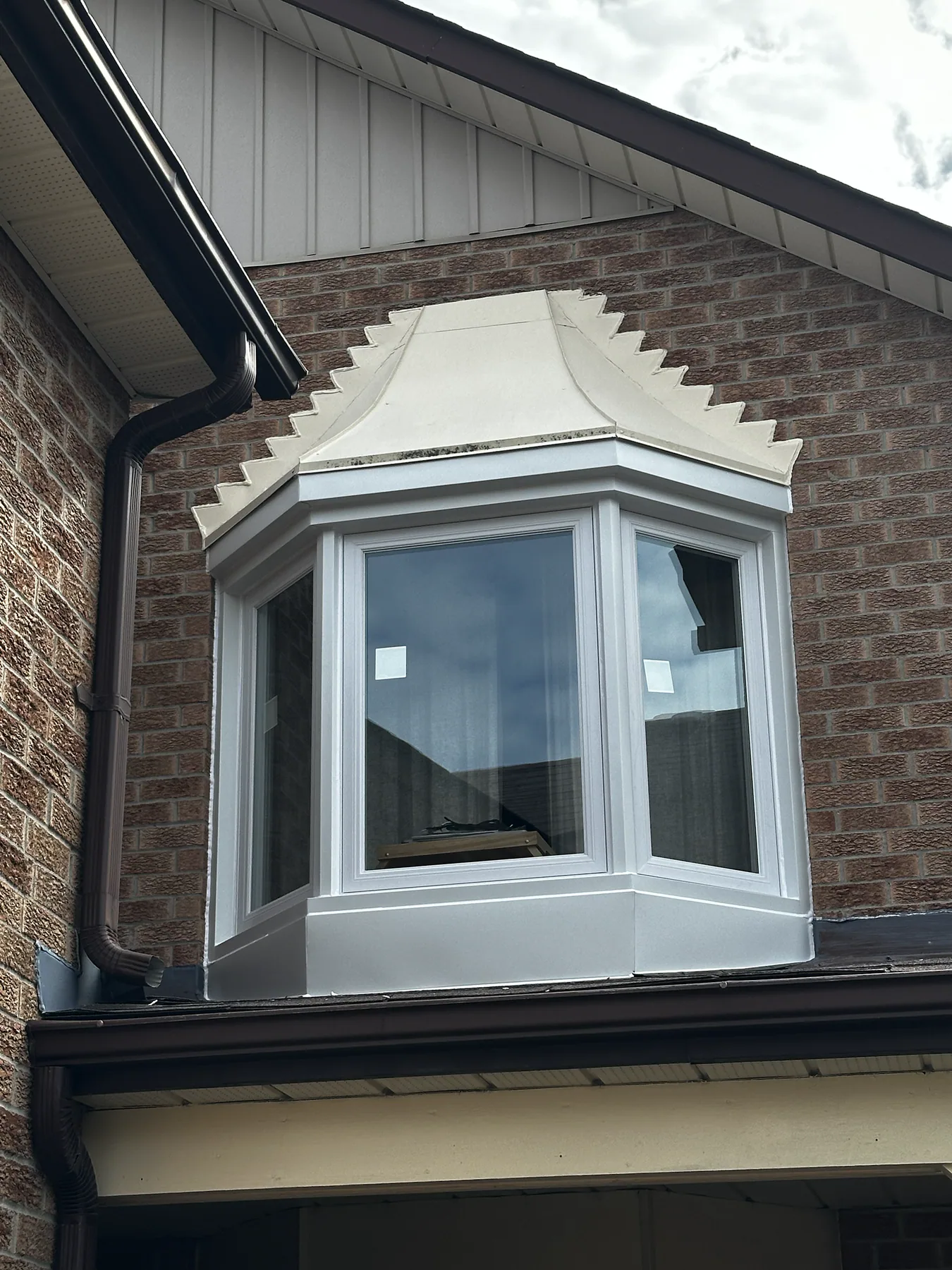 Finished upper-storey white bay window