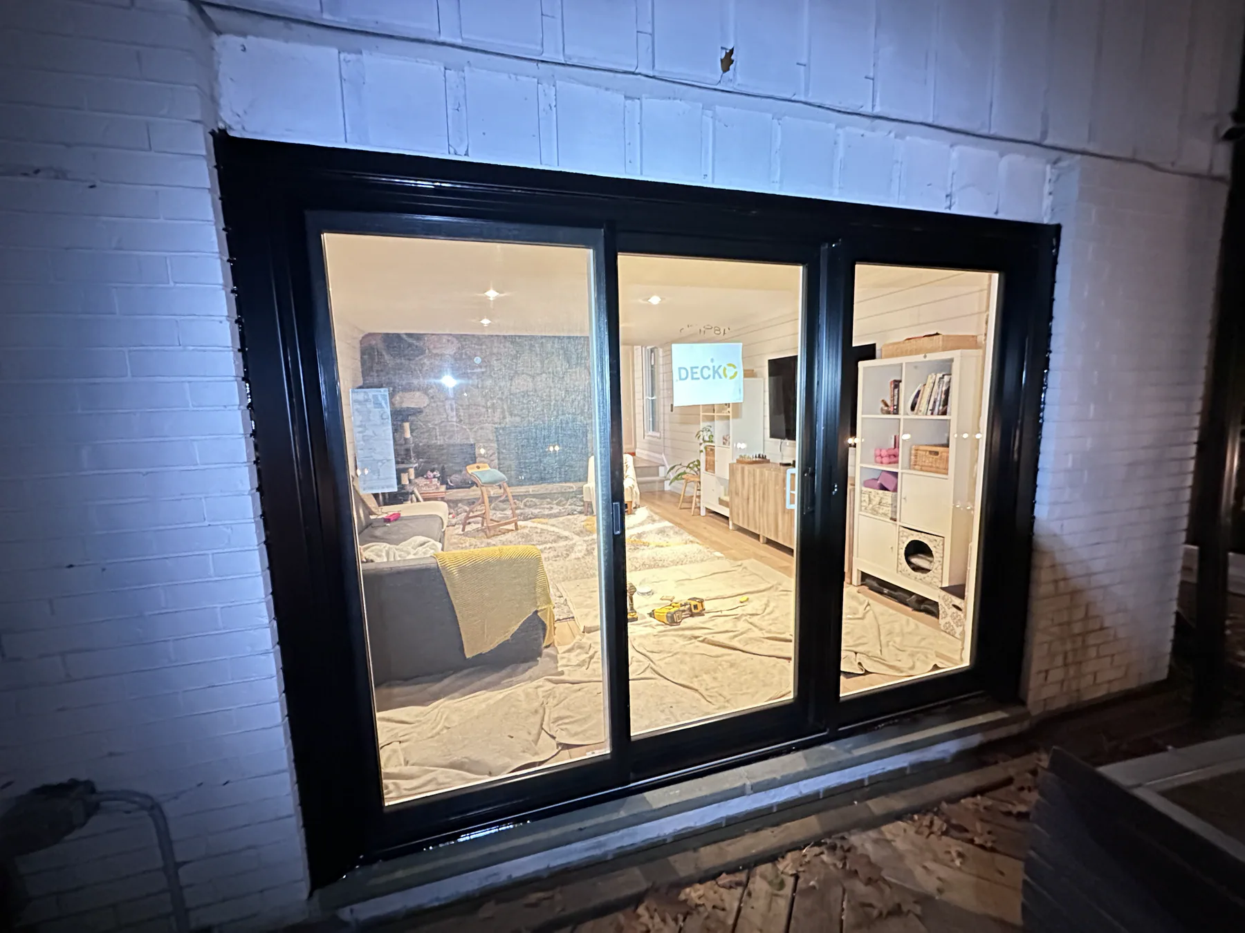 Black glazed patio door viewed from the exterior at night