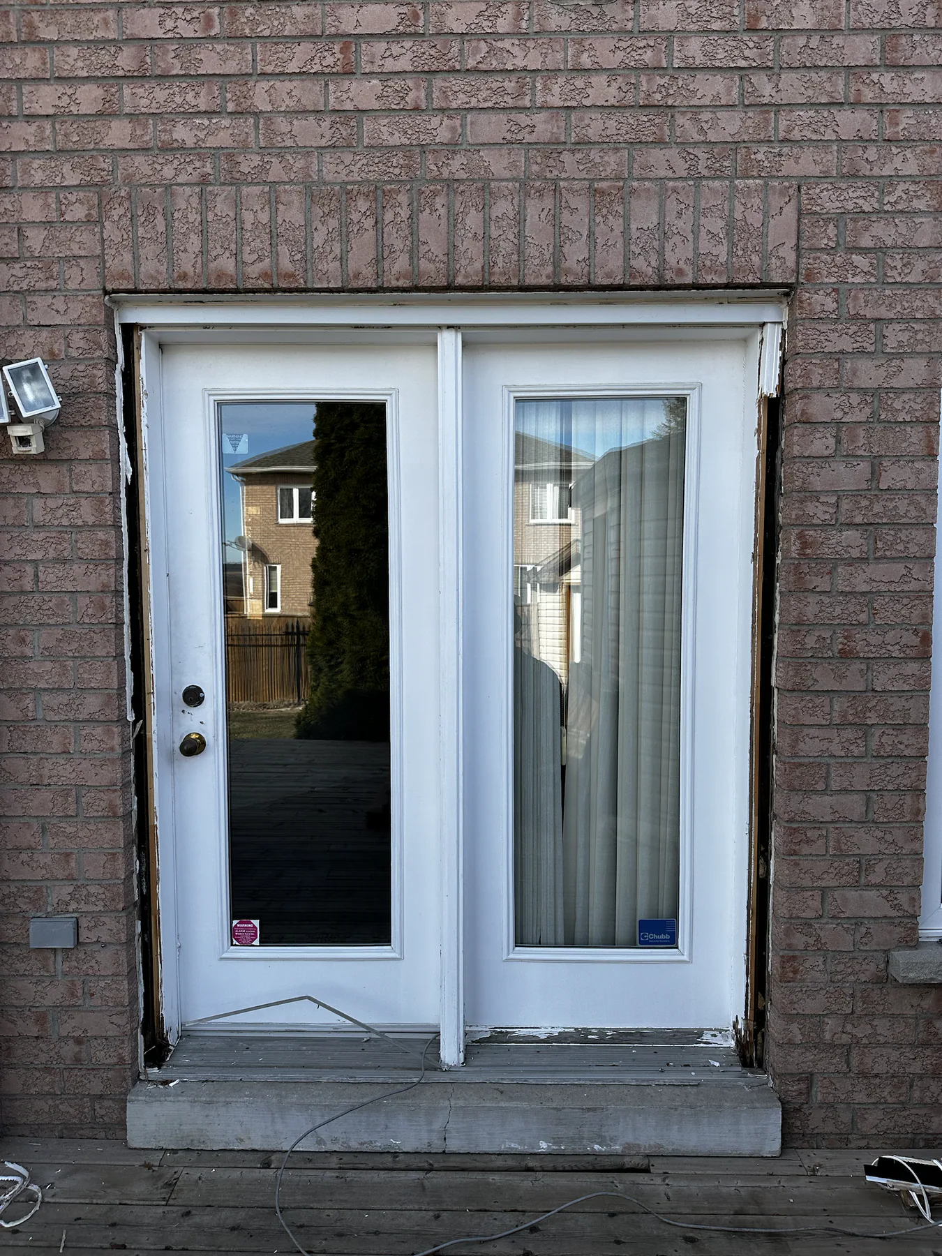Original white hinged garden door before replacement