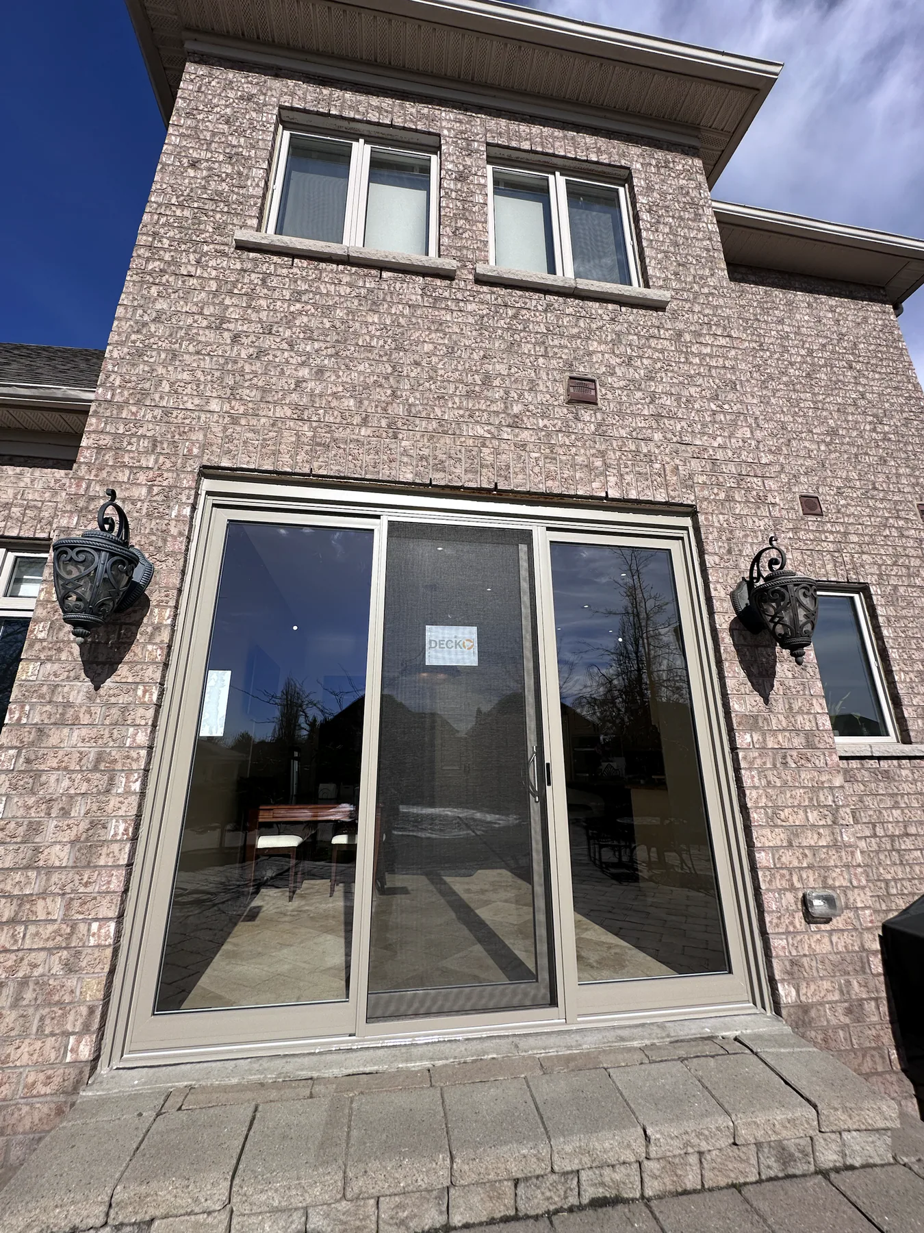 Finished patio door installed in the rear brick wall