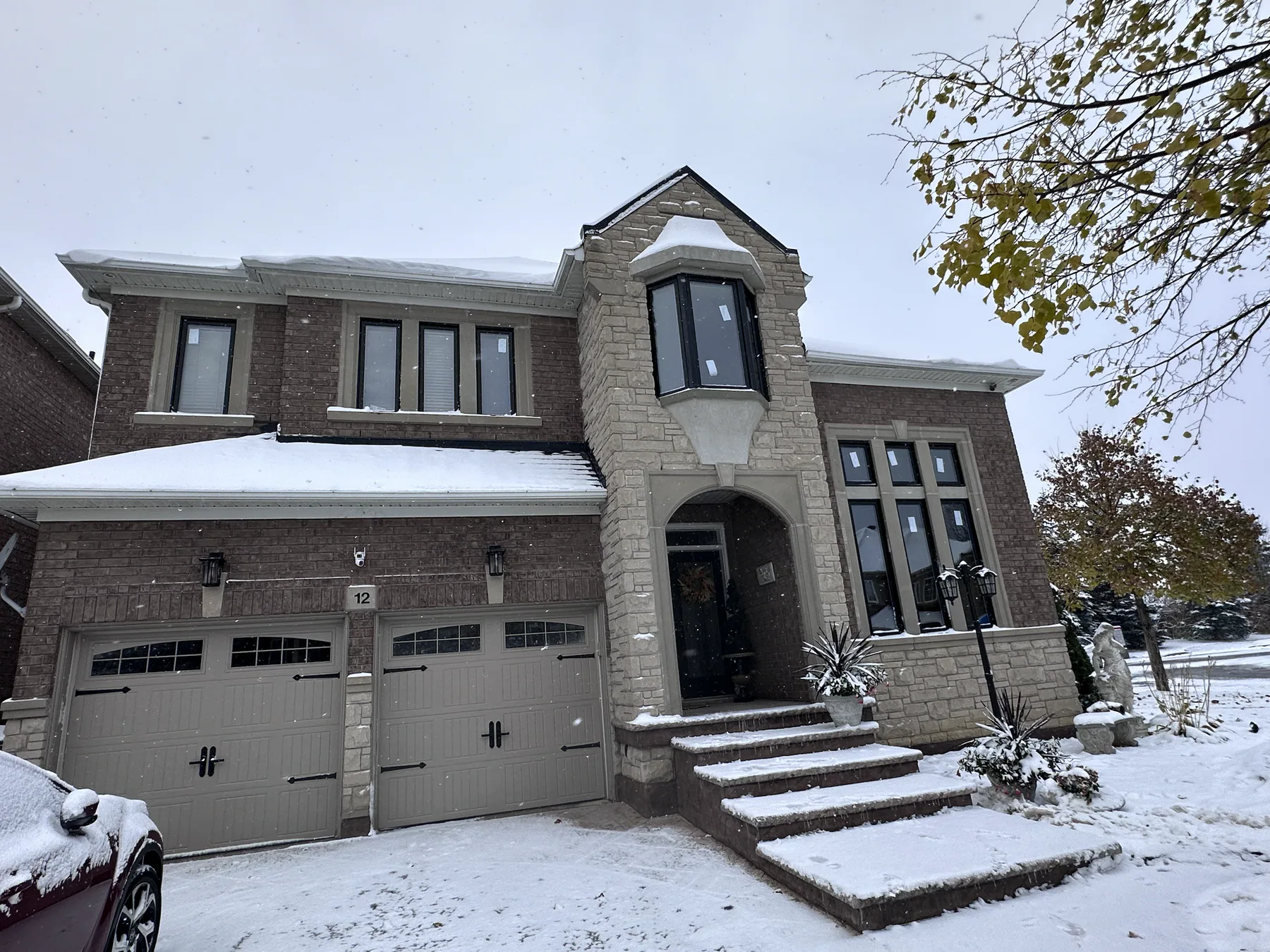 Brick home with coordinated black-framed replacement windows