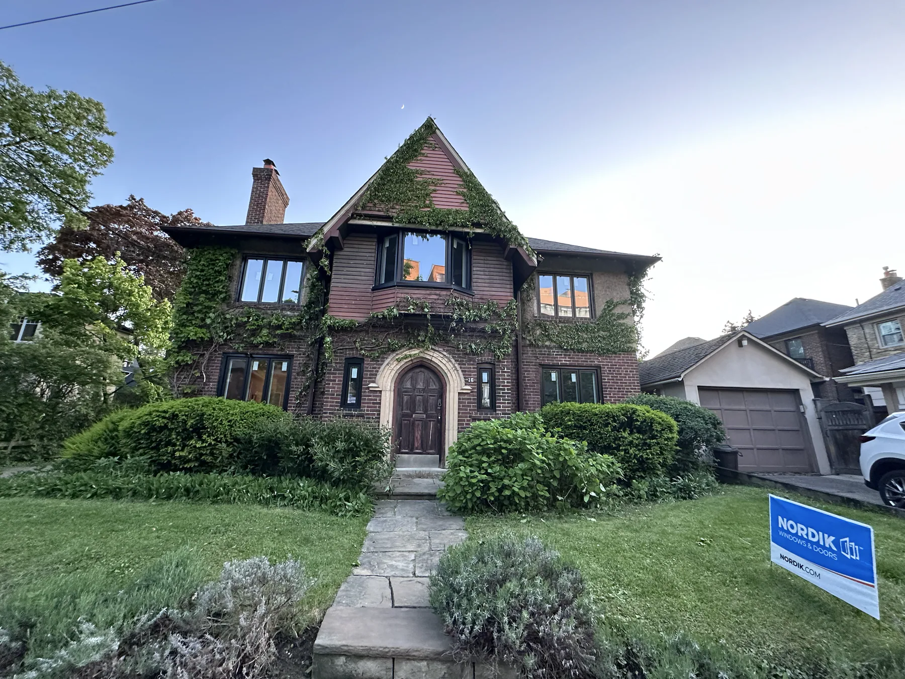 Heritage brick home after a coordinated window replacement